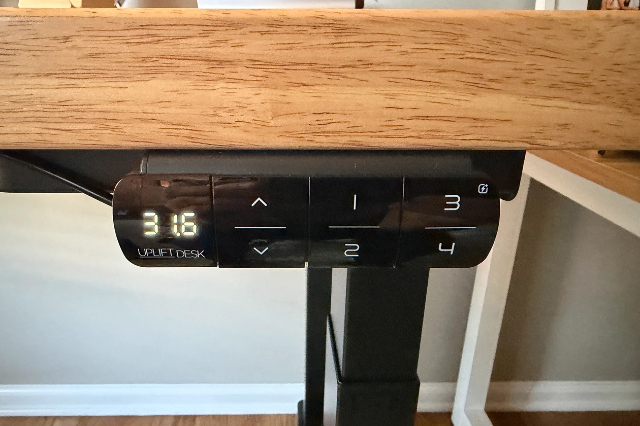 Advanced memory keypad mounted beneath the front edge of the UPLIFT V3 4-Leg Standing Desk
